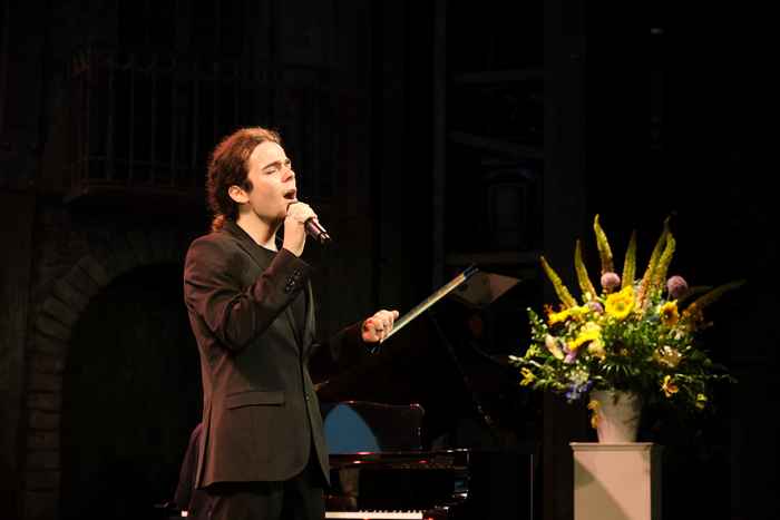 Lucas Serralta singing on stage at Carre