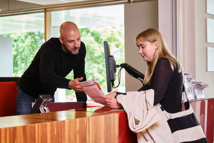 AUC student at the Service Desk being helped by an AUC employee